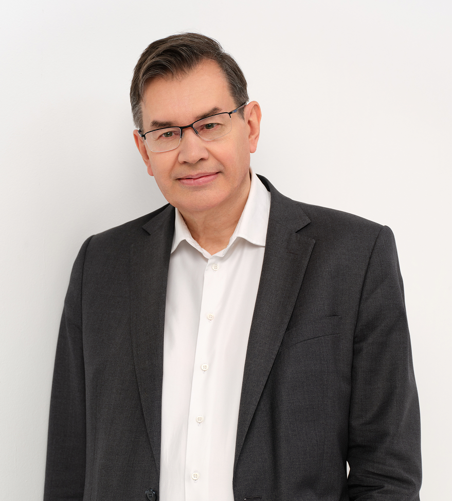 Man in suit and glasses smiling